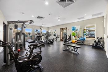 the gym is equipped with weights and other exercise equipment at the enclave at stone creek
