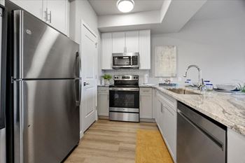 a kitchen with stainless steel appliances and marble counter tops