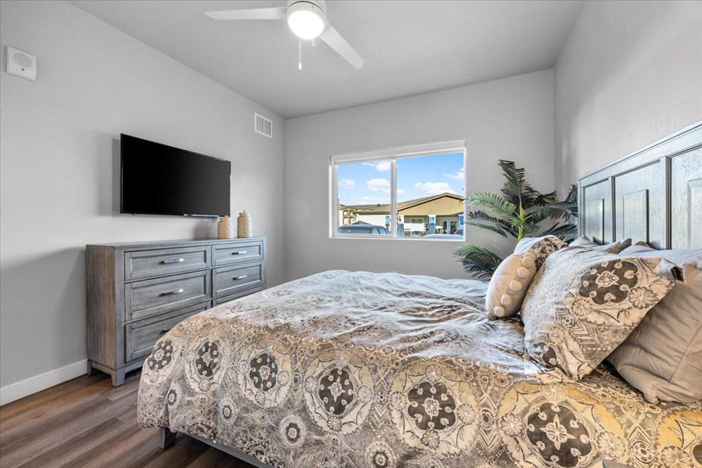 a bedroom with a bed and a tv