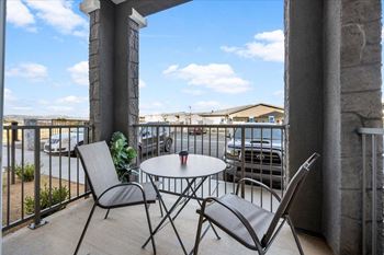 a patio with a table and chairs on a balcony