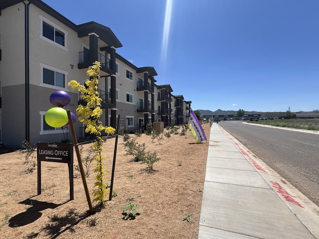 a row of new apartment buildings on the side of the road