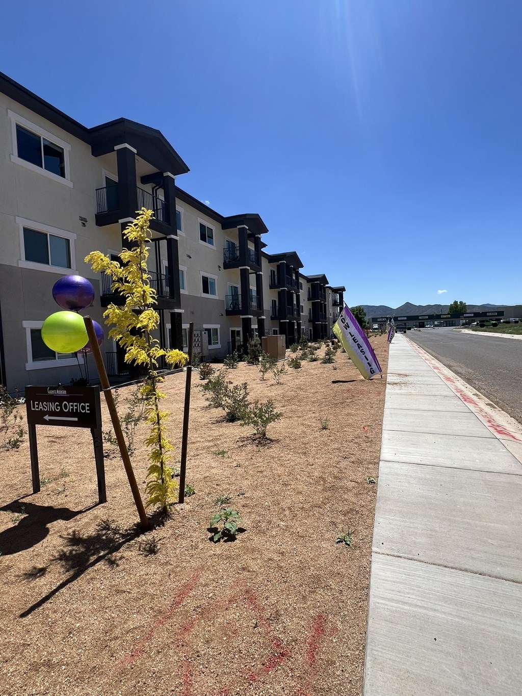 a row of new apartment buildings on the side of a street