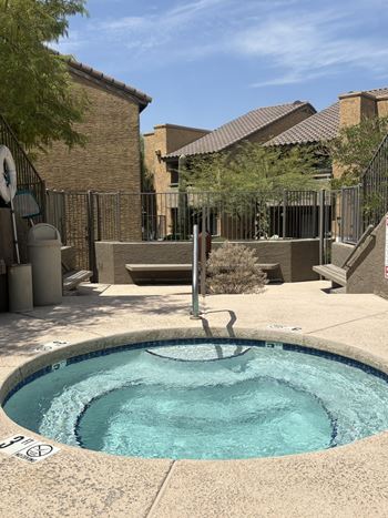 A small pool with a fence around it.