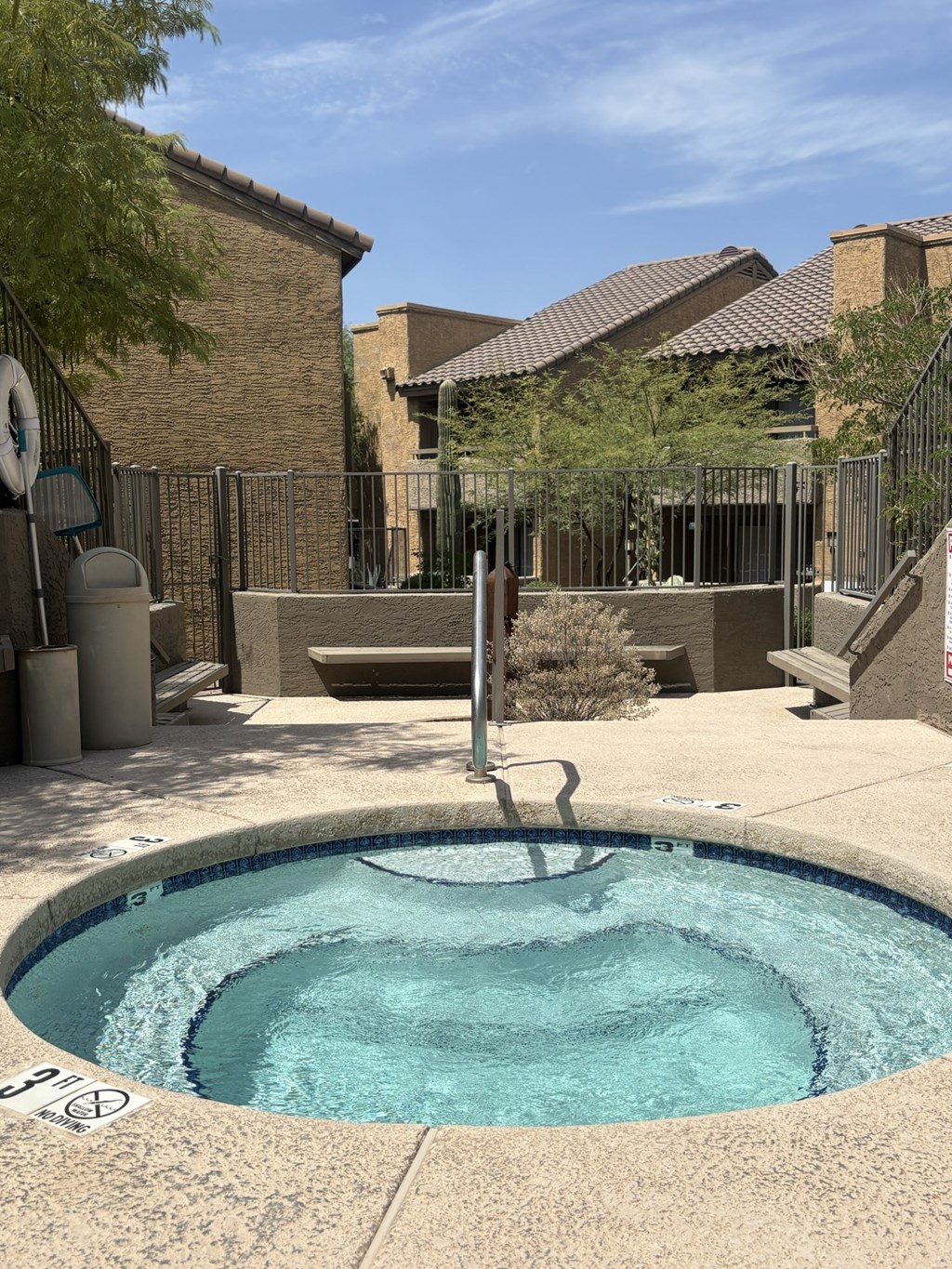 A small pool with a fence around it.