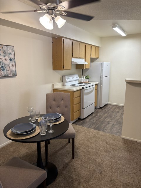 A small kitchen with a table set for two.