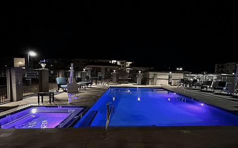 a swimming pool at night with a blue glow in it