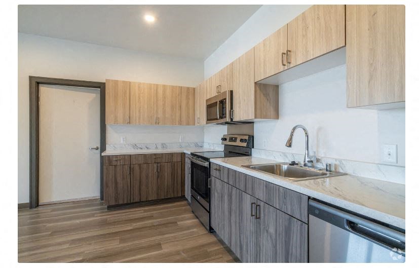 a kitchen with wooden cabinets and a sink