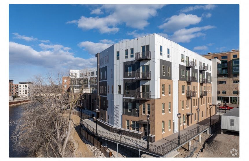 a building with a bridge in front of a river