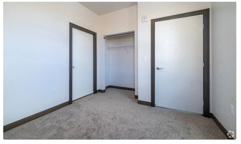 a room with two closets and two doors