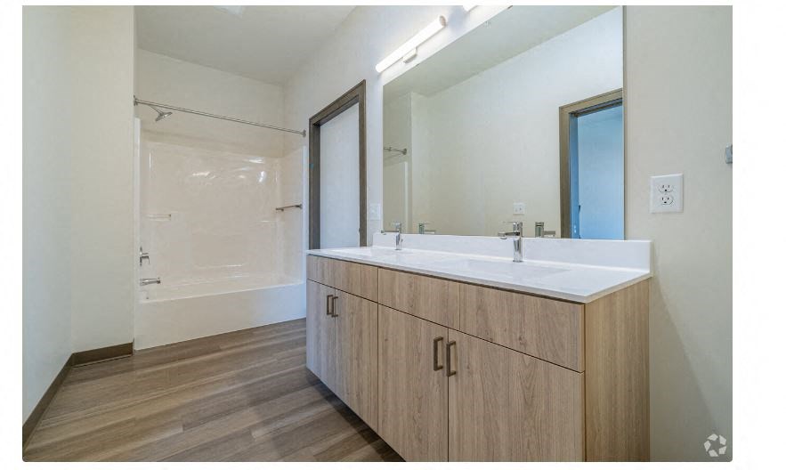a bathroom with a sink and a large mirror