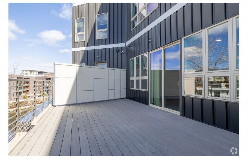 a large balcony with a view of a city