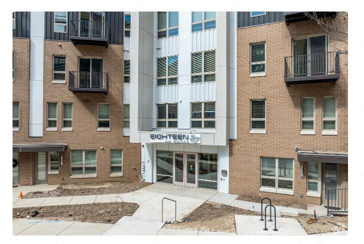 an apartment building with a sign on the front of it