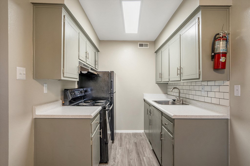 Galley Style Kitchen with Black Appliances