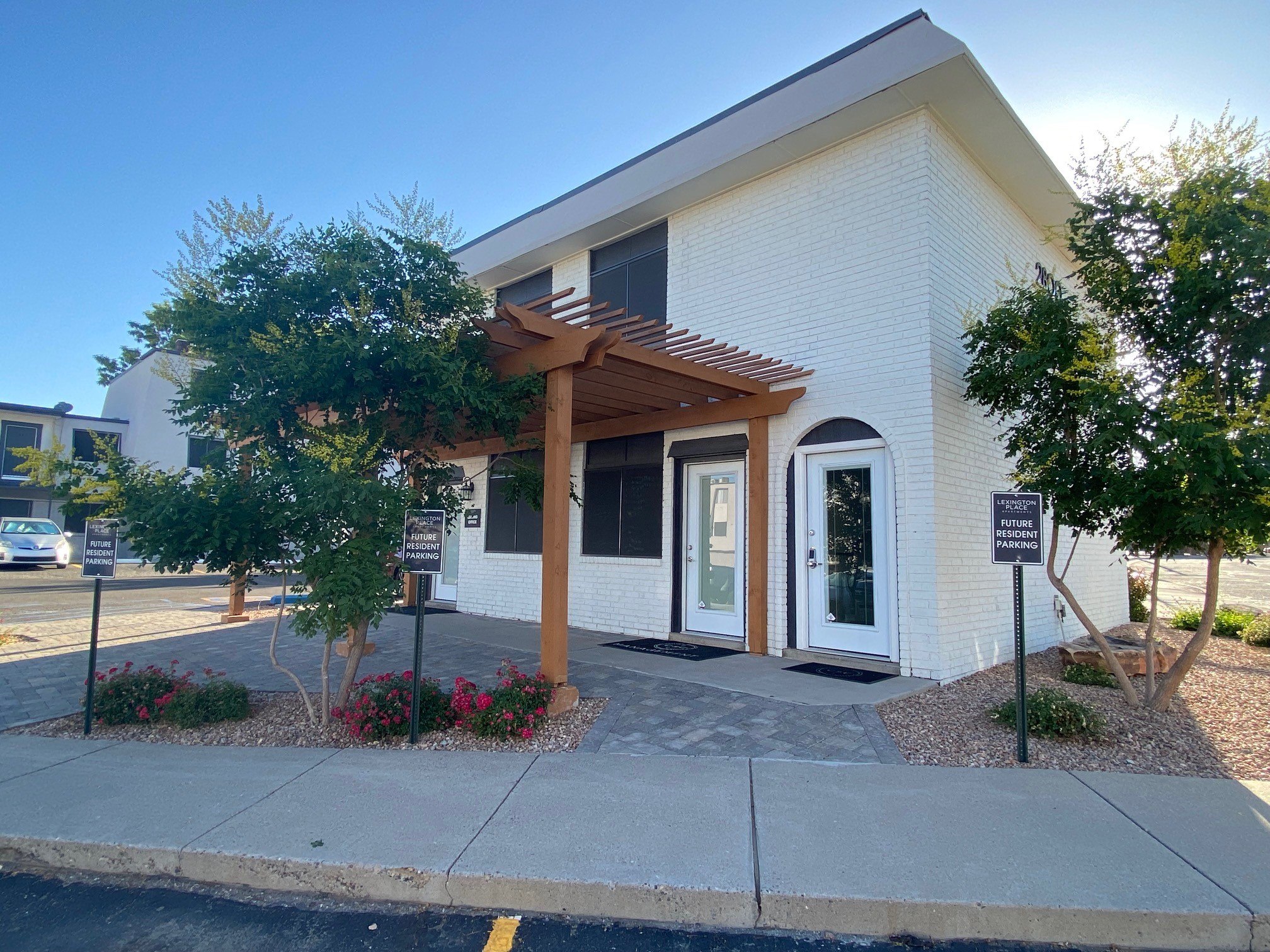 the front of a building with awning and a sidewalk