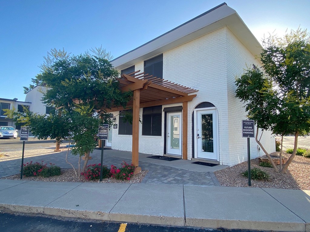 the front of a building with awning and a sidewalk