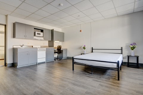 a patient room with a bed and a kitchen
