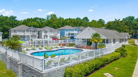 A large white house with a pool in the backyard.