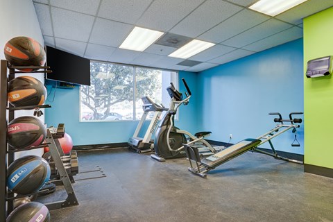 a gym with exercise equipment and a window