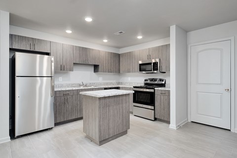 a kitchen with stainless steel appliances and a white refrigerator