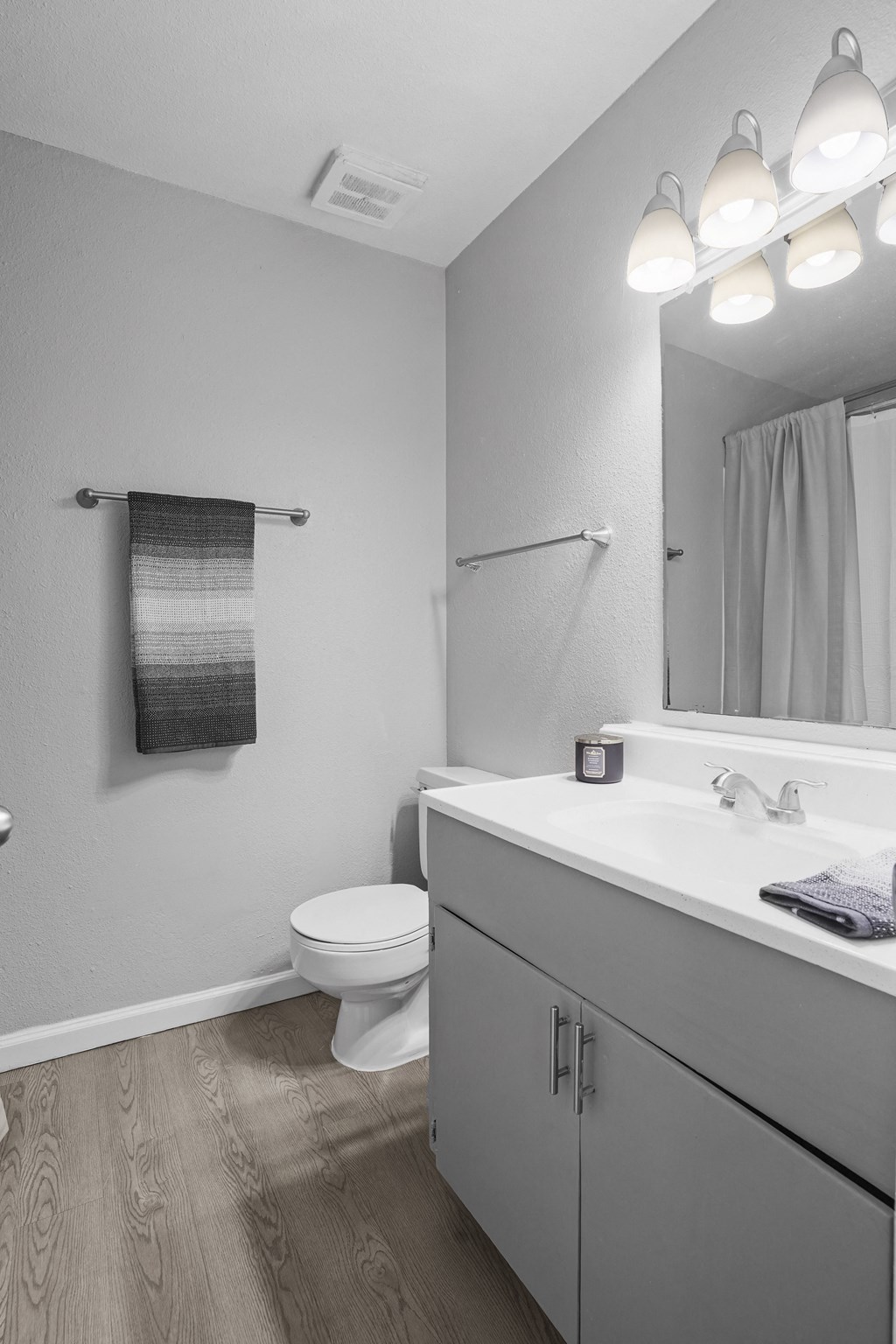 a bathroom with a sink and a toilet and a mirror