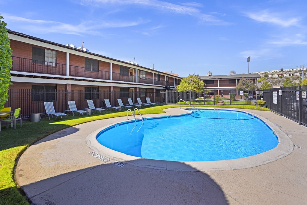 a resort style pool is shown in front of an apartment building