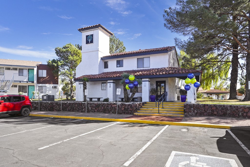 a parking lot in front of a building with balloons