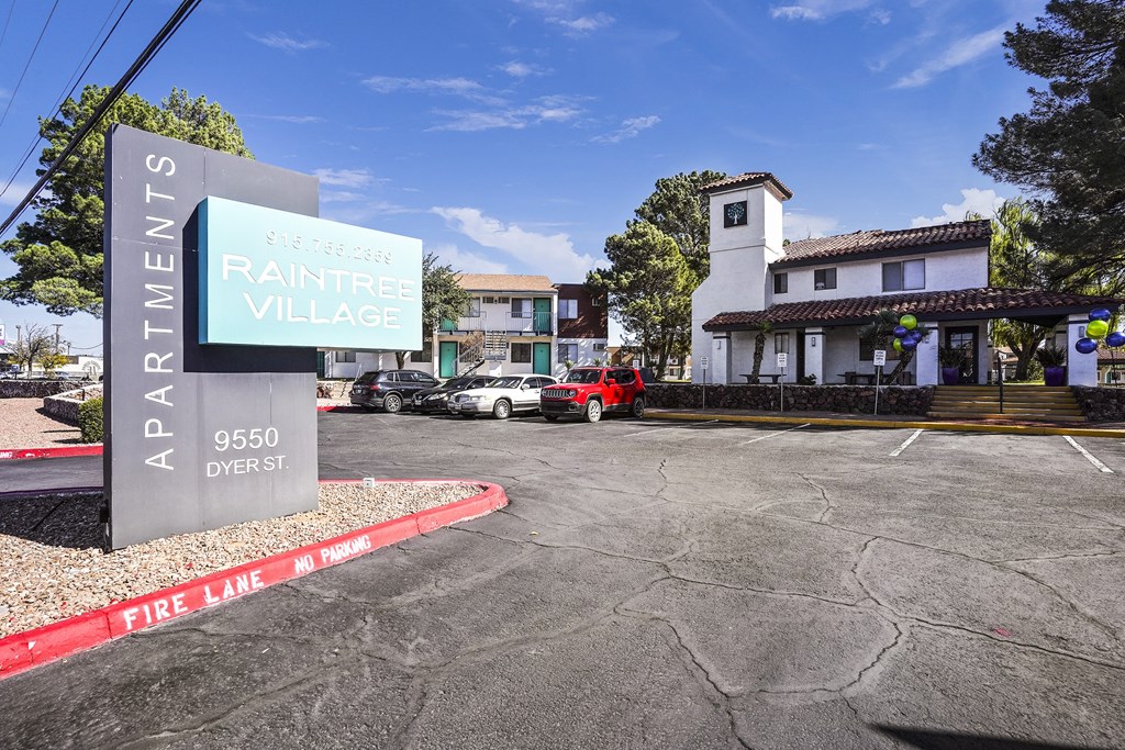 a parking lot with a sign that reads rainier village
