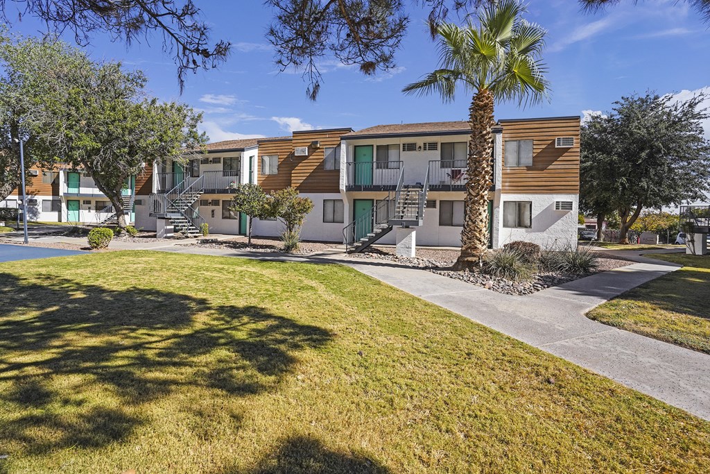 an apartment building with palm trees in front of it