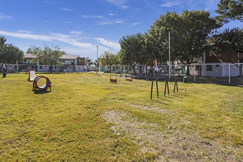 a yard with a playground and a chain link fence