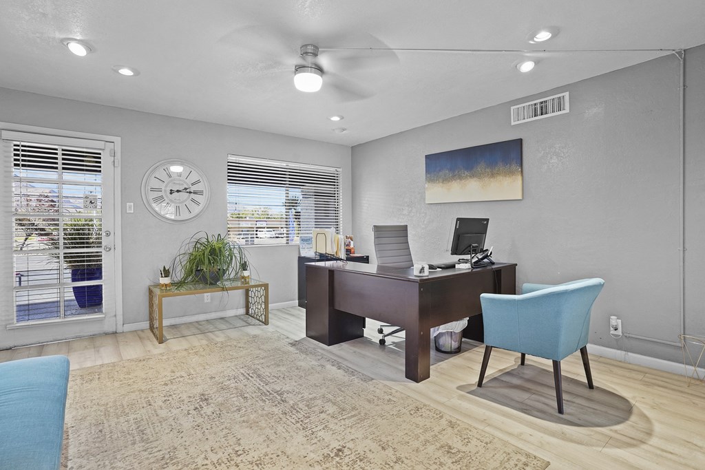 a home office with a desk and a clock on the wall