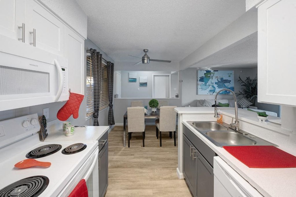 a kitchen with a stove top oven and a sink