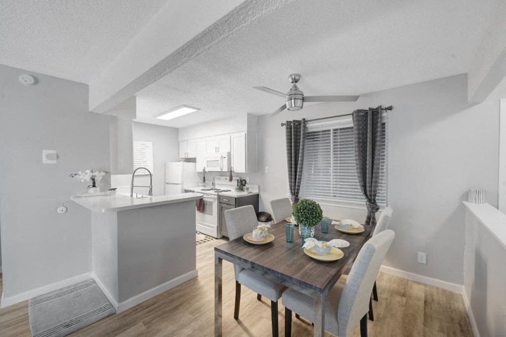an open kitchen and dining room with a table and chairs