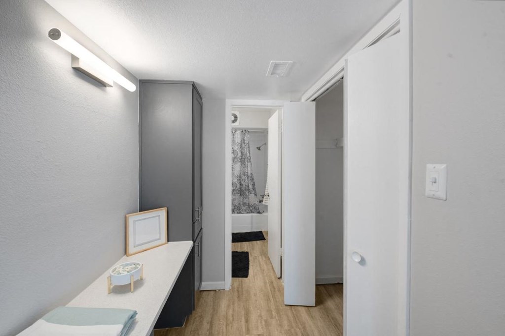 a white room with a desk and a mirror