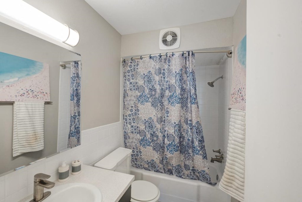 a bathroom with a shower curtain and a sink