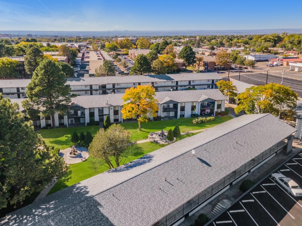 an aerial view of a neighborhood with houses and a parking lot