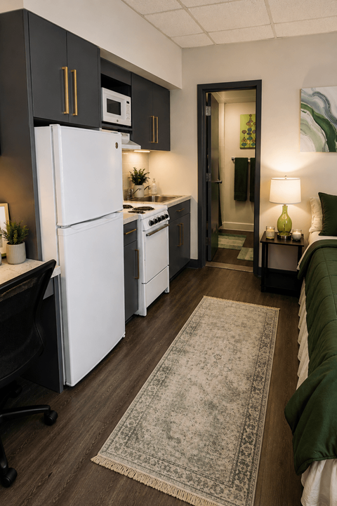 A kitchen with a white fridge and a black chair.