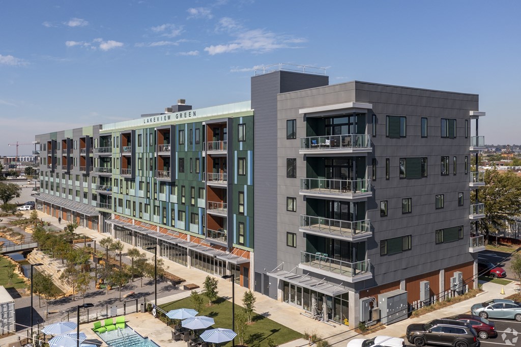 an aerial view of a building with balconies and a parking lot