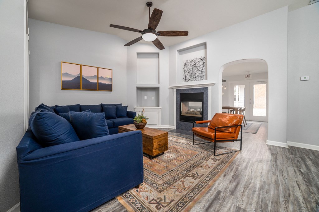 an open living room with a blue couch and a fireplace