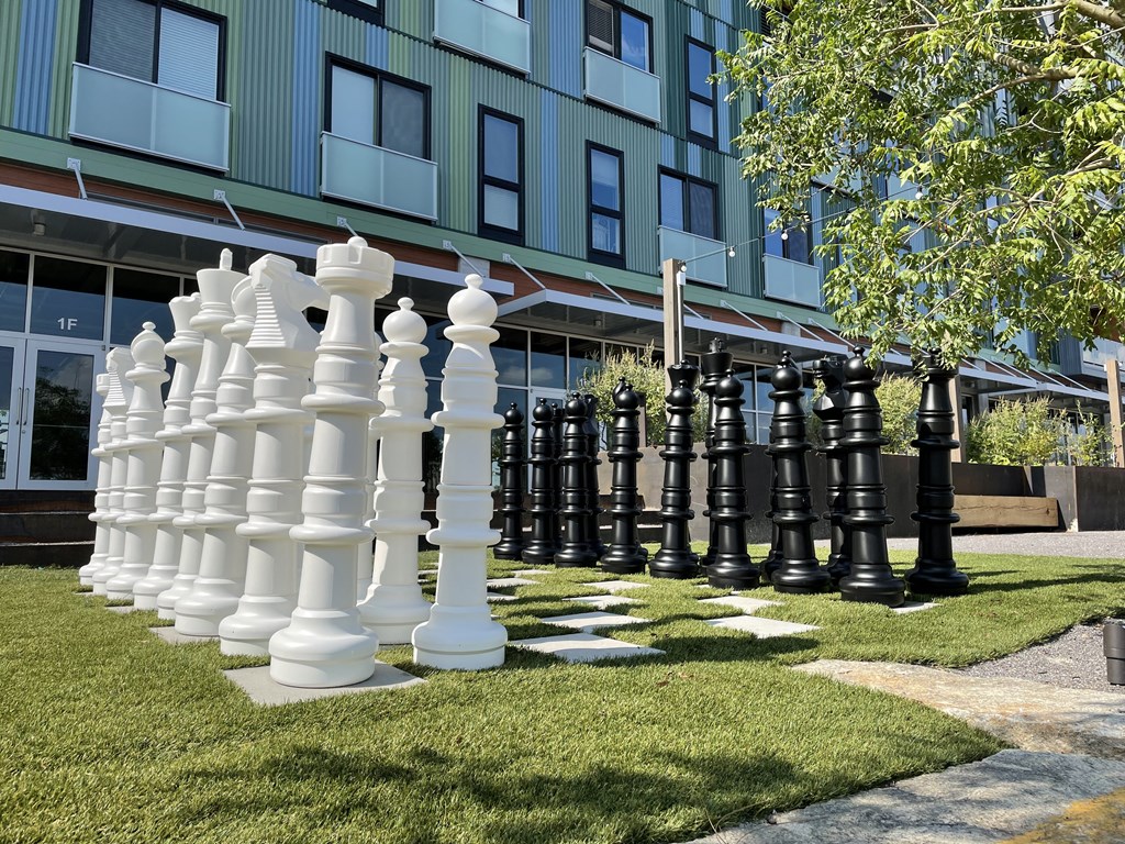 a giant chess set in front of a building