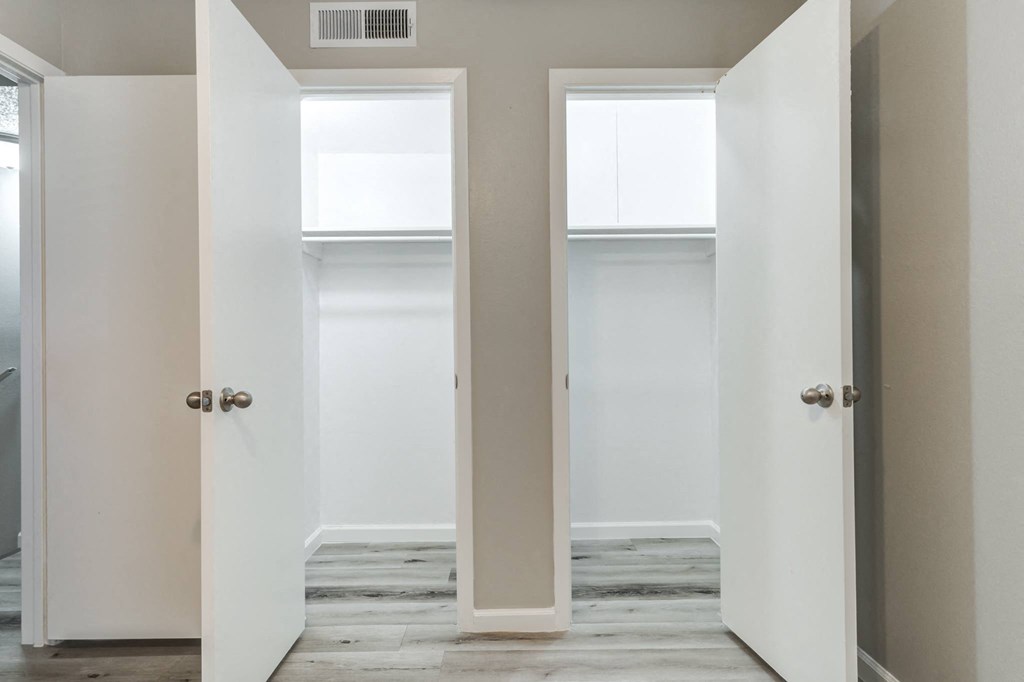 an empty room with two doors and a window