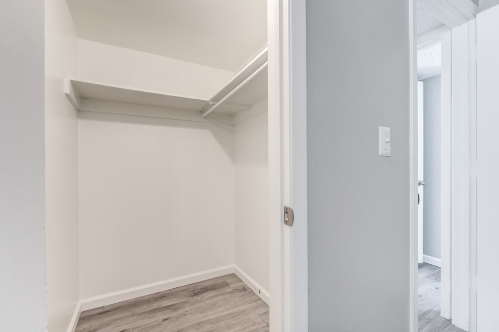 an empty room with white walls and a door