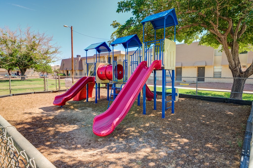 a playground with colorful slides at a park