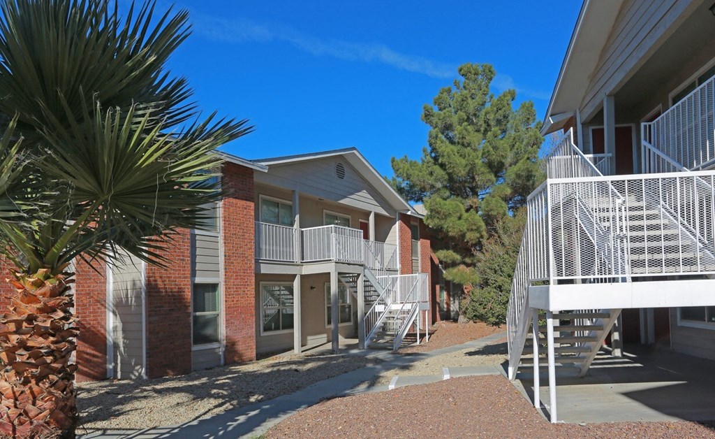 an exterior view of a building with stairs and balconies