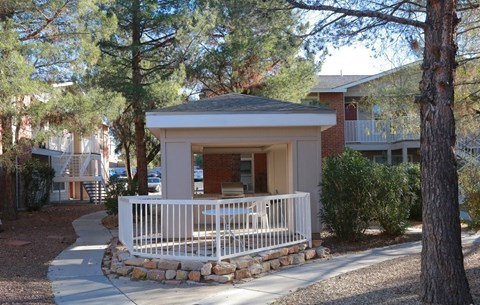 a small gazebo with a porch in front of a building