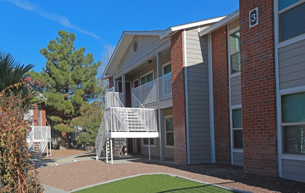 an exterior view of a building with a balcony and stairs
