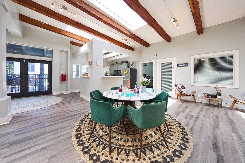 a dining room with a table and chairs and a rug