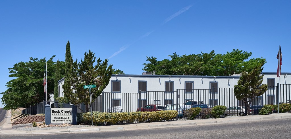 a white building with a sign on the side of a street
