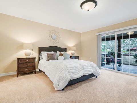 a bedroom with a bed next to a sliding glass door