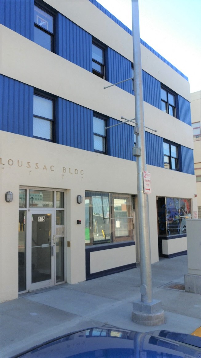 a blue and white building with a street pole in front of it
