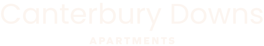 A sign that says Canterbury Downs Apartments.